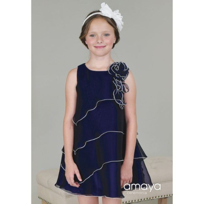 Vestido Amaya Fashion for Kids Moda Teen marino con corte evasé, volantes y flor decorativa en el hombro.